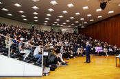 A full lecture hall in conversation with Michael Sandel