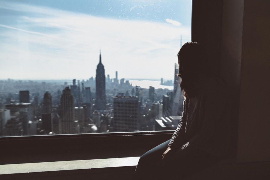 Woman looking out of the window at Top of The Rock, New York City